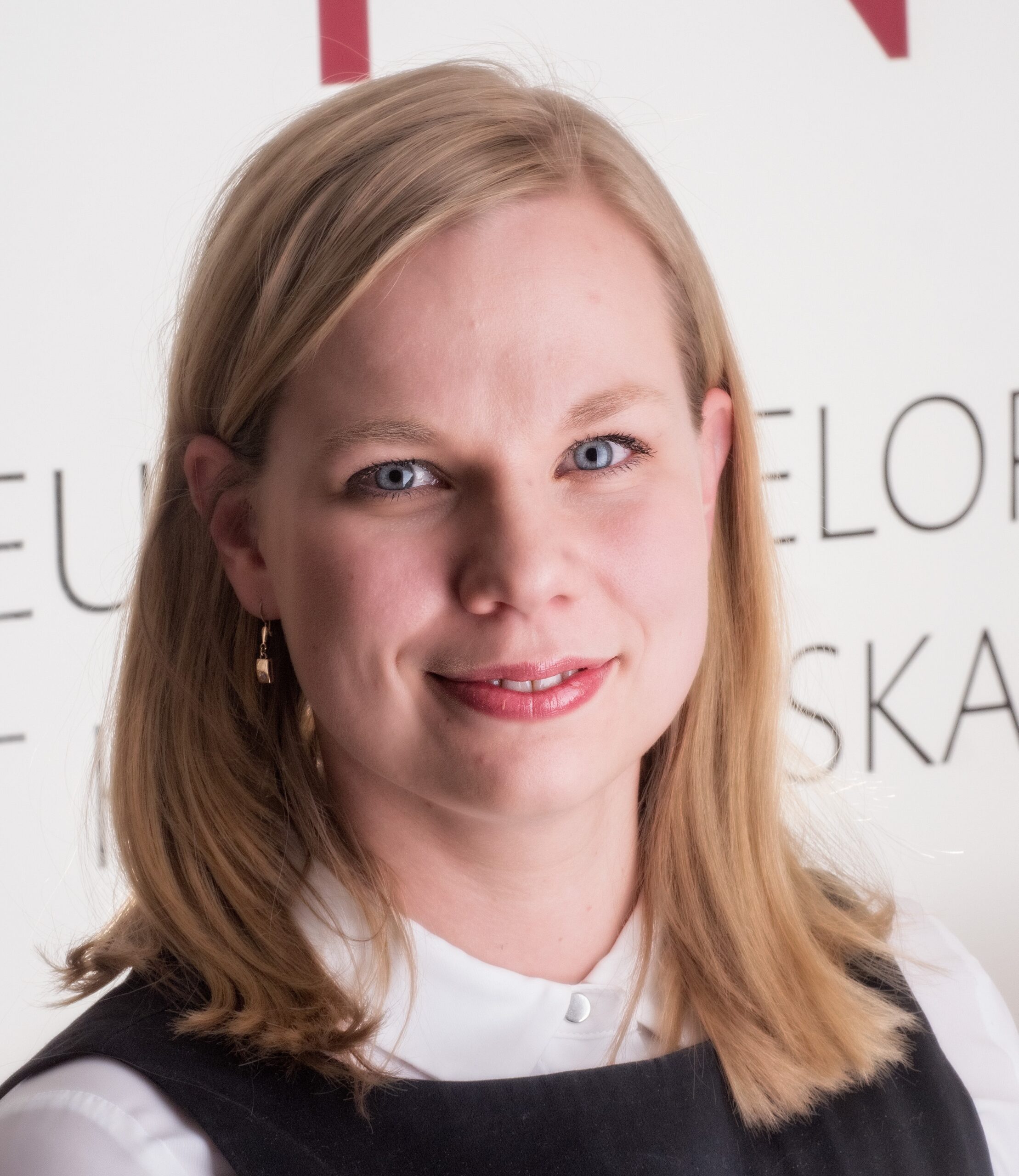 Dr. Kristiina Tammimies, a blonde researcher, smiles at the camera