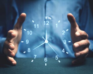 Image of man holding a clock