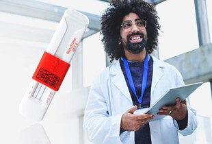 Scientist in a lab coat standing next to the Microscreen OFT from Thermo Fisher Scientific