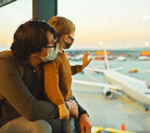 Image: masked family at airport watching planes