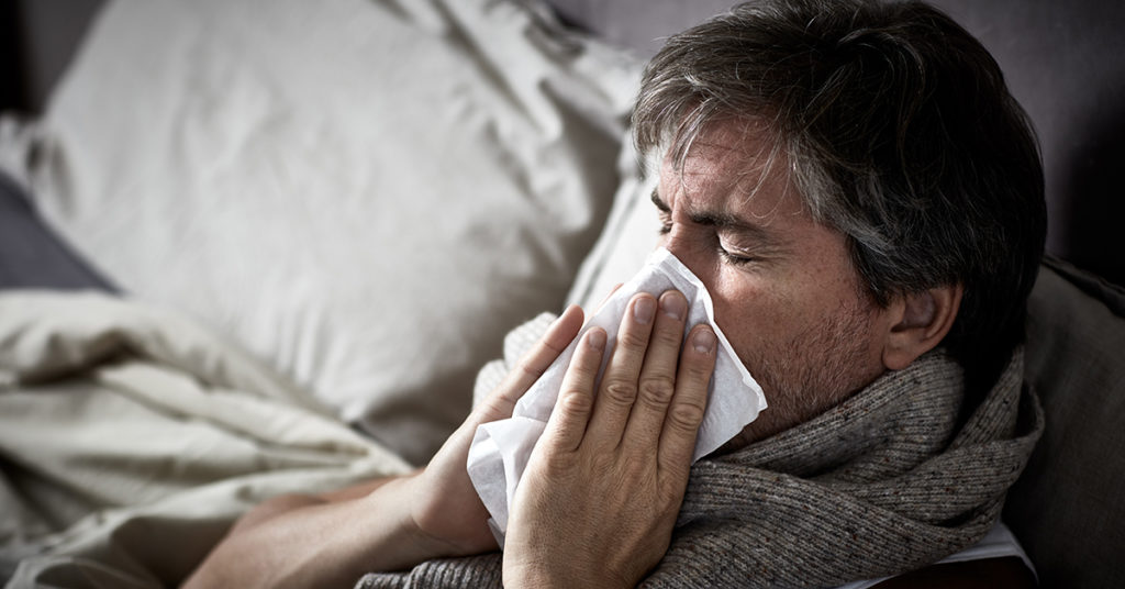 A man blowing his nose