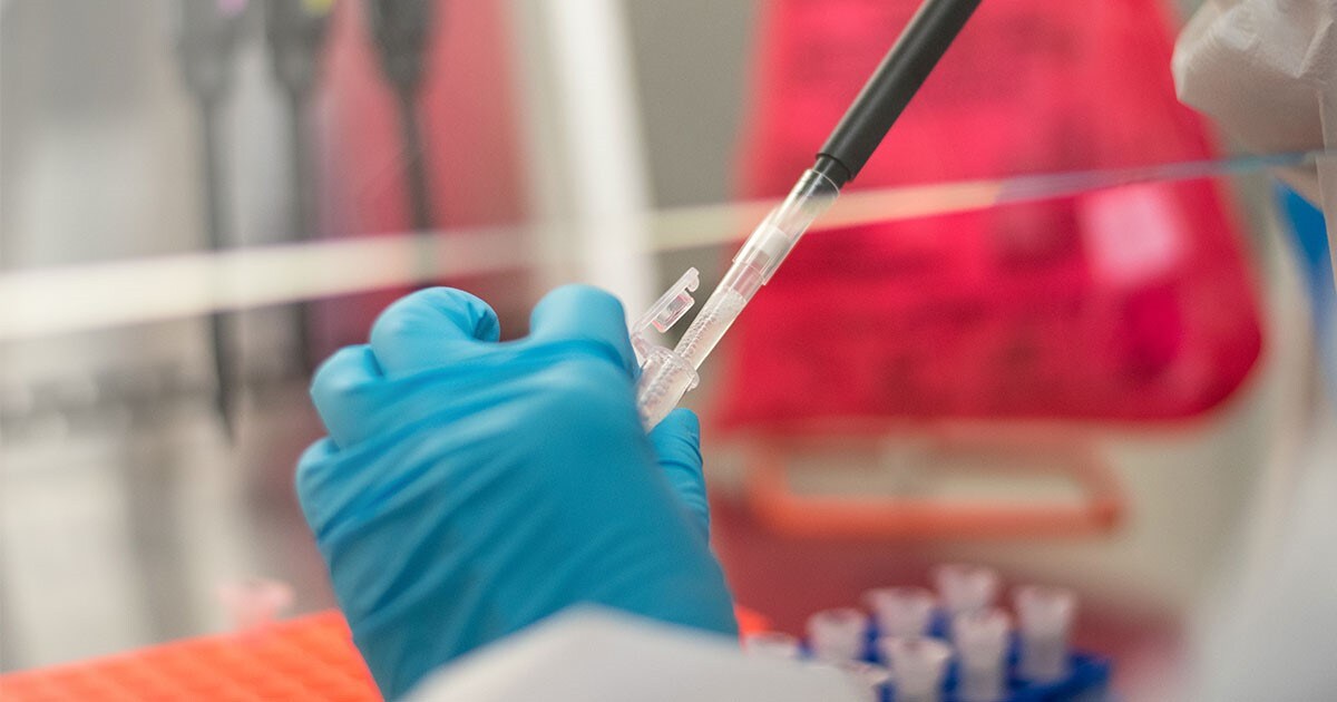 Technician testing a sample in a lab