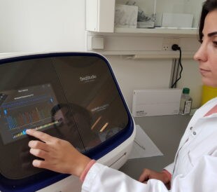 A scientist uses the SeqStudio Genetic Analyzer