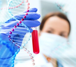 A lab tech holds a vial of blood with a graphic of DNA over it, representing a liquid biopsy
