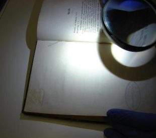Astronomy book and magnifying glass