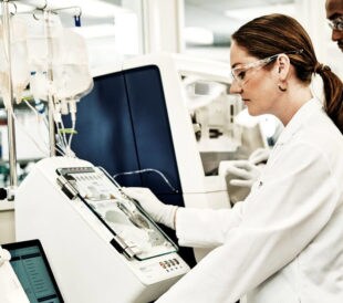 scientist using CTS Rotea Counterflow Centrifugation System to showcase closed system automation for cell therapy
