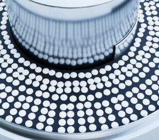 White tablets on the conveyor.