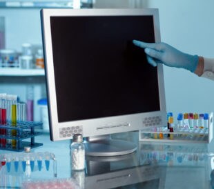 Scientist working with computer in a lab. Image: angellodeco/Shutterstock.com