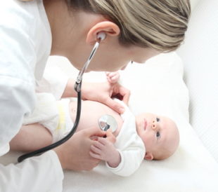 A pediatrician with baby checking possible heart defect. Image: riopatuca/Shutterstock.com.