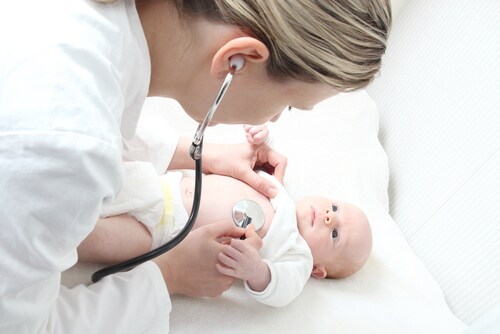 A pediatrician with baby checking possible heart defect. Image: riopatuca/Shutterstock.com.