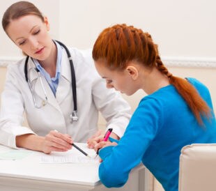 Doctor advises woman patient. Image: NotarYES/Shutterstock.com.