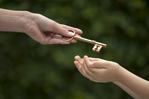 Mother handing key to daughter. Image: eelnosiva/Shutterstock.com.