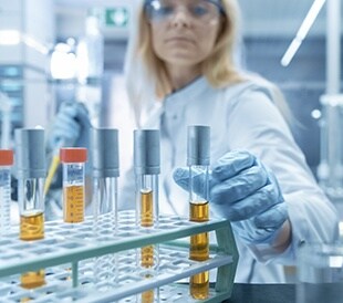 Scientist in lab reaching for test tube