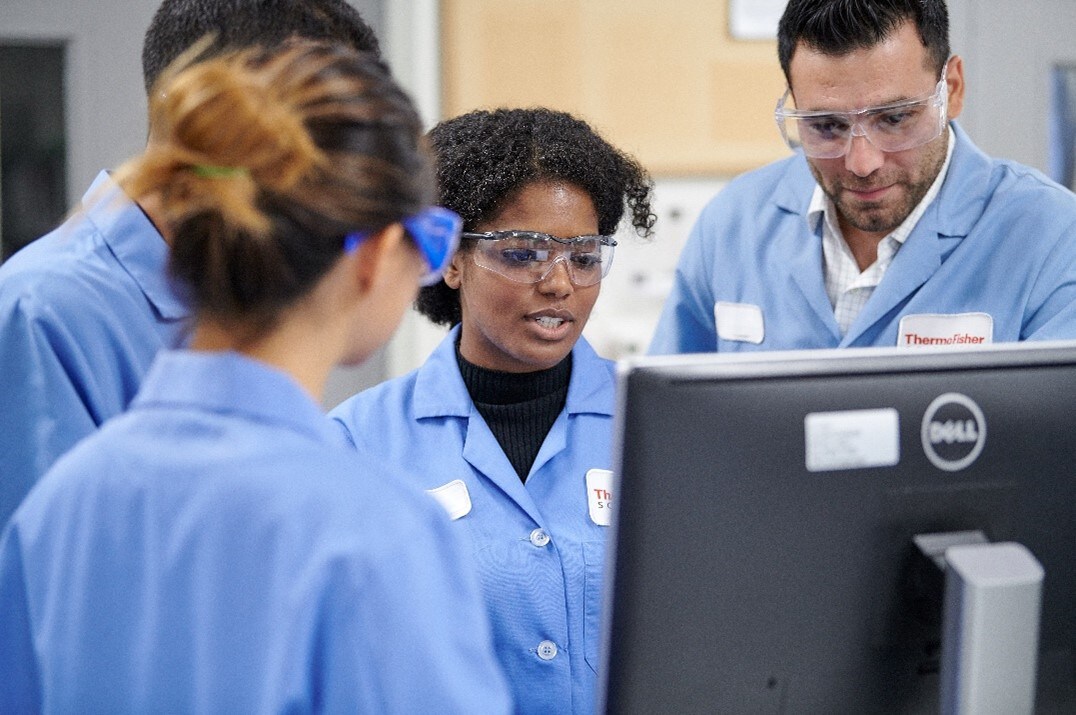 Scientists in blue lab coats