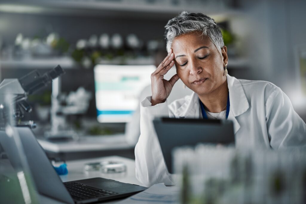 Female scientist in a lab, looking frustrated