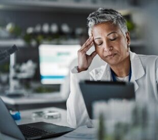 Female scientist in a lab, looking frustrated