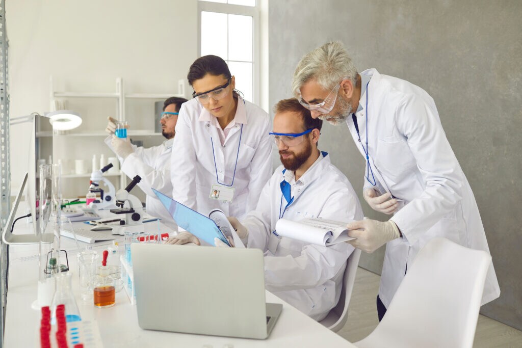 Three scientists reviewing results in a laboratory