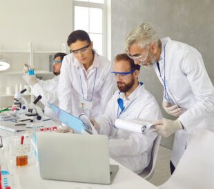 Three scientists reviewing results in a laboratory