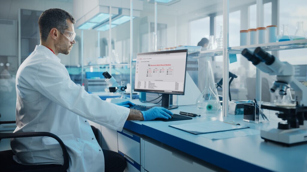 Scientist working in bioanalytical lab on a desktop computer