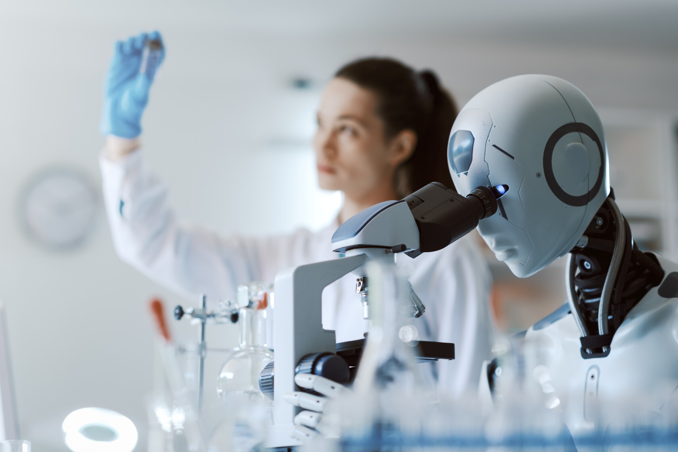 Female scientist and AI robot working together in the science lab