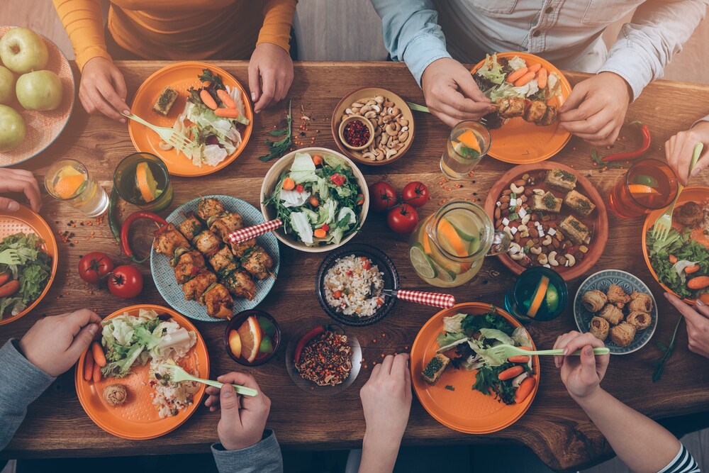 Top view of people eating on a rustic wooden table