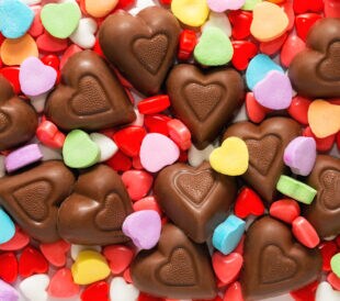 Pile of assorted chocolate and sugar heart shaped Valentine's Day candy