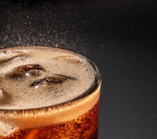 Fizz sparkling Cola water Refreshing bubbly Soda Pop with Ice Cubes. Cold soft drink cola carbonated liquid fresh and cool iced drink in a glasses . Refreshing and quench thirst concept