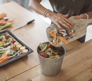 Women preparing vegetable meal for cooking, everything is so green, healthy and freshly harvested from garden. Making compost from leftovers.