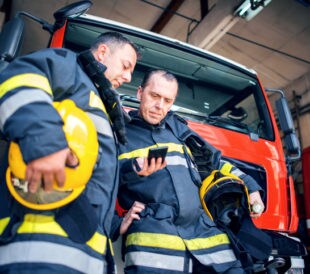 First responders reading smart phone.