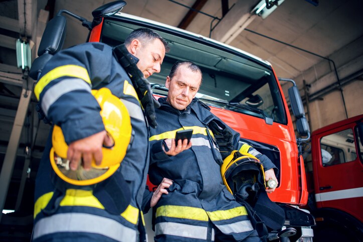 First responders reading smart phone.