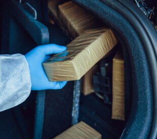 Packages of narcotics in car trunk. Drug smuggling.