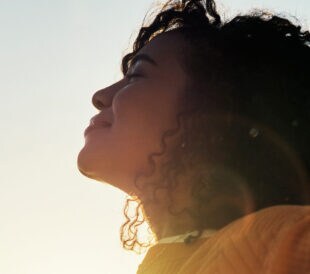 picture of sky with a woman outdoor at sunset during summer to relax with fresh air and sunshine. Happy, carefree and mockup with a young female feeling relaxed