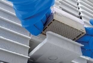 Scientist pulling samples out of ultra-low temperature freezer