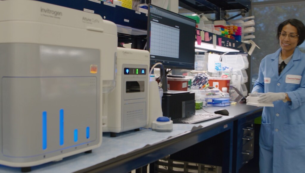 A female scientist prepares to load samples into the Attune CytPix flow cytometer with new automated imaging analysis 