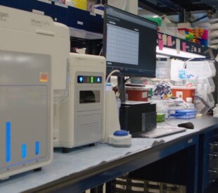 A female scientist prepares to load samples into the Attune CytPix flow cytometer with new automated imaging analysis