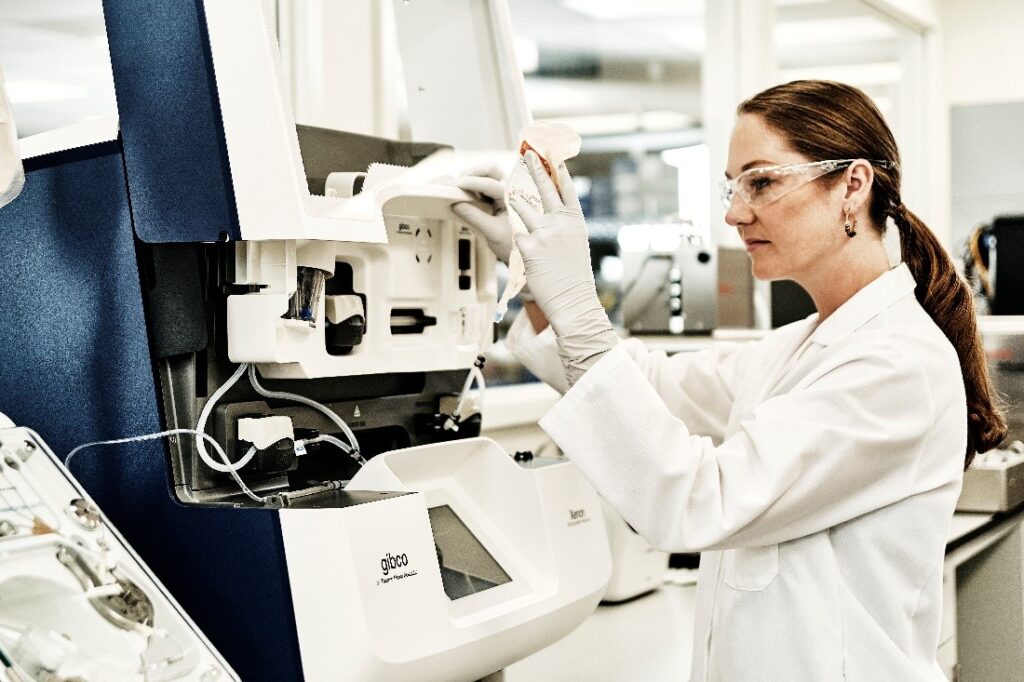 A researcher uses the CTS Xenon Electroporation system for non-viral transfection in cell therapy manufacturing.
