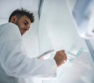 scientist at whiteboard