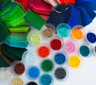 several dyed plastic polymer granulates in laboratory