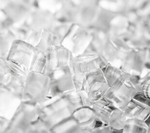 Transparent Plastic in granules. Polymer pellets. Isolated on a black background.