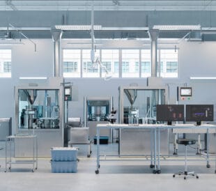 Digitally generated image of inspection laboratory in medicine production factory. 3D render of empty laboratory with scientific monitors on desks.
