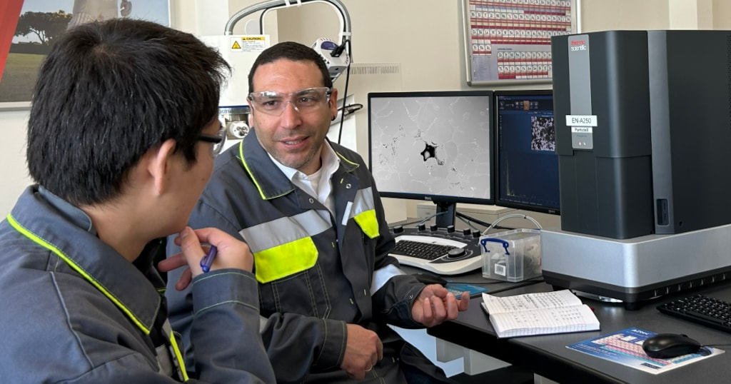 Dr. Ugur Kayran and Marc Liu beside the Phenom ParticleX Desktop SEM