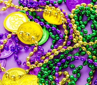 Multicolored decorations for Mardi Gras party on the table.