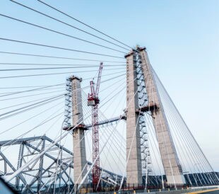 Metal fasteners, such as screws, nuts, bolts, and clamps, are critical components in manufacturing and construction. Fasteners are made from steel, brass, aluminum, or other metals, depending on the design specifications of the application for which they are being used. Fasteners made with the wrong alloy can result in costly or even catastrophic consequences. Fortunately, inspection and verification of metal alloys used in fasteners can be quickly and easily accomplished using handheld x-ray fluorescence (XRF) analyzers. XRF is a nondestructive testing technique that can analyze a metal sample in seconds with little to no need for sample preparation. A recent example of possibly defective metal fasteners was uncovered during the construction of the Mario M. Cuomo Bridge, a new 3.1 mile twin-span bridge which replaces the Tappan Zee Bridge across the Hudson River in New York. The New York Times reports that the New York attorney general’s office is investigating why a small number of steel bolts intended for the new bridge unexpectedly fractured during the construction process. As first reported by WNBC-TV, some of the allegations were filed by a former safety inspector and suggested that the bolts failed due to hydrogen embrittlement. However, a study obtained by The Times and conducted by engineering firm, Alta Vista, concluded that there was “compelling evidence” that hydrogen embrittlement “is not a cause of the observed bolt failures.” Instead, it said, the fractured bolts were “likely due to occasional material defect or occasional over-tightening.” According to the Nace.org web site, “hydrogen embrittlement is a type of deterioration which can be linked to corrosion and corrosion-control processes. It involves the ingress of hydrogen into a component, an event that can seriously reduce the ductility and load-bearing capacity, cause cracking and catastrophic brittle failures at stresses below the yield stress of susceptible materials. Hydrogen embrittlement occurs in a number of forms but the common features are an applied tensile stress and hydrogen dissolved in the metal. Examples of hydrogen embrittlement are cracking of weldments or hardened steels when exposed to conditions which inject hydrogen into the component. Presently this phenomenon is not completely understood and hydrogen embrittlement detection, in particular, seems to be one of the most difficult aspects of the problem. Hydrogen embrittlement does not affect all metallic materials equally. The most vulnerable are high-strength steels, titanium alloys and aluminum alloys.” To help prevent critical components from failing due to material defect, handheld XRF analyzers are indispensable tools for performing Positive Material Identification (PMI) of incoming raw material to ensure it matches the alloy grade and composition documented on the material test report prior to product manufacture. It is also used for final quality inspection before finished parts are sent to the customer. This “double-check” process helps ensure that the incoming raw materials and the outgoing finished parts meet the expected engineering requirements. To learn more, read Quality Assurance of Critical Fasteners.