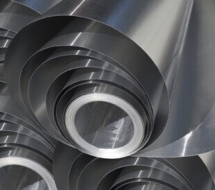 pile of rolled silver aluminum metal. set of industrial materials