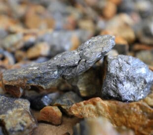 Antimony (Sb) mine, mining. Stibnite ore (antimonite, antimony trisulfide) background. Critical mineral, raw material. Metal used solder, bullets, plain bearings, alloys, lead-acid batteries