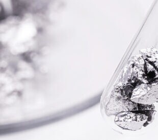 metal spatula with chromium ore, industrial use ore, metallic chemical element, isolated on white background