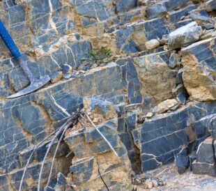 Geological hammer on the rocks pre mining technology