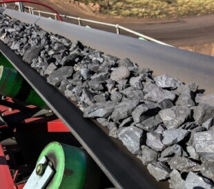 Close up of Manganese rock being moved on a conveyor belt