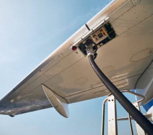 Ground service before flight. Refueling of airplane at airport.