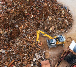 An aerial drone view of a metal scrapyard.